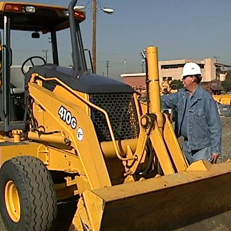 Operator Inspecting Backhoe Loader Pre-Shift Walk Around Inspection: Backhoes — AP Safety Training